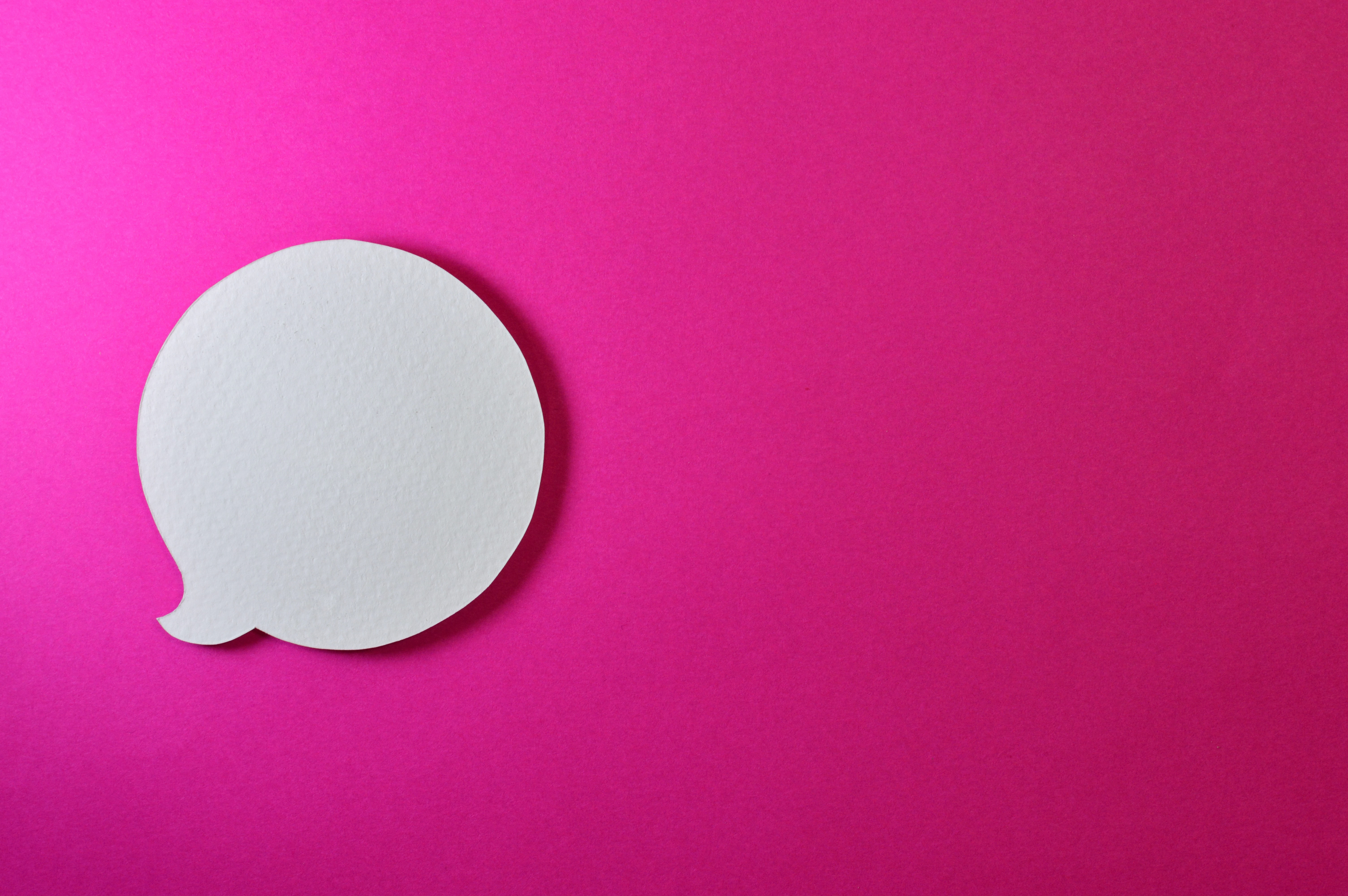 Paper speech bubble on a pink background